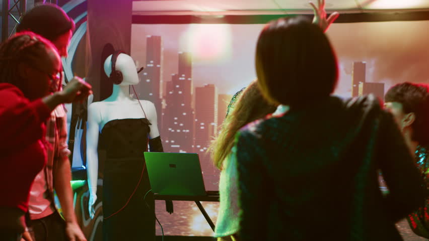 Young man clubbing with people at bar, having fun with DJ mixing station on nightclub stage with disco ball. Funky person creating live performance on audio panel, spotlights at club. | Shutterstock HD Video #1104023513