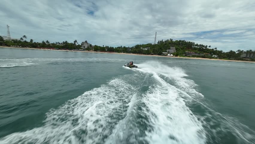 Jet ski from FPV drone in Sri Lanka, Ceylon island. Mirissa bay in Indian ocean