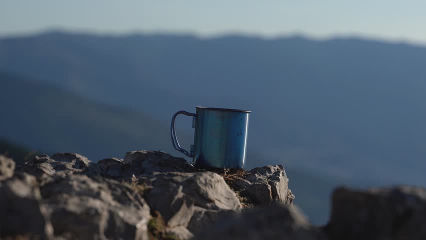 Coffee Bliss with a View: capturing a person pouring freshly brewed coffee from a coffee maker against the backdrop of a mountain landscape, blending the joy of a warm beverage with the beauty of natu