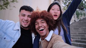 Group of happy multicultural young friends smiling and looking at camera having a video call. Cheerful teenage students having fun on a meeting. Three joyful people bonding on a social gathering. High