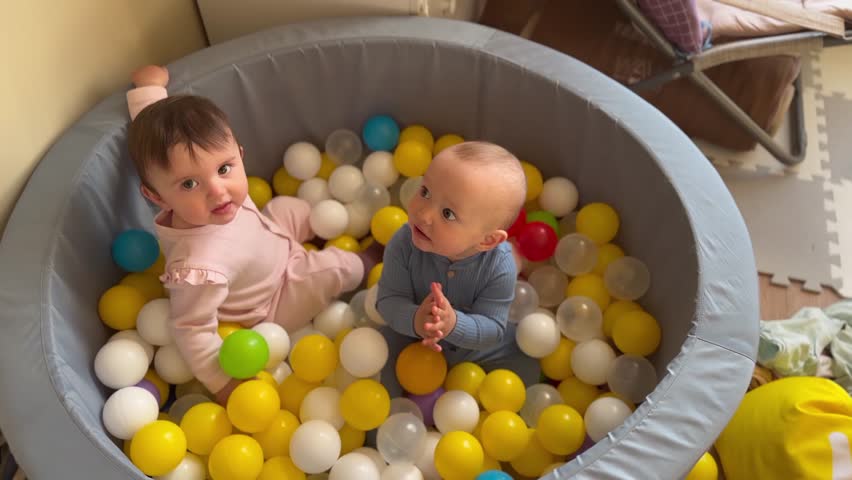 baby play. group of baby children play balls in a dry pool. happy family kid dream concept. baby in kindergarten playing in a dry pool. playroom with balls lifestyle in the pool baby twins play Royalty-Free Stock Footage #1104028055