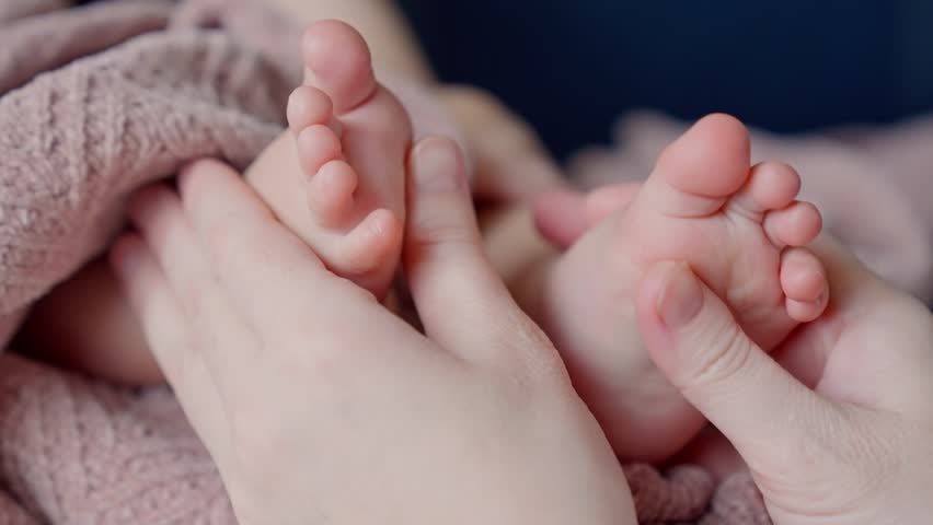 Mom doctor gives foot massage to her baby. happy family kid baby concept. Children massage: care and care of the doctor mother. Foot massage baby health: doctor mom help dream. baby foot massage Royalty-Free Stock Footage #1104028157