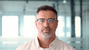 Headshot close up portrait of indian or latin confident mature good looking middle age leader, ceo male businessman on blur office background. Handsome hispanic senior business man looking at camera. - Powered by Shutterstock - Get 15% off with code: PIKWIZARD15
