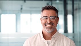 Headshot close up portrait of indian or latin confident mature good looking middle age leader, ceo male businessman on blur office background. Handsome hispanic senior business man smiling at camera. - Powered by Shutterstock - Get 15% off with code: PIKWIZARD15