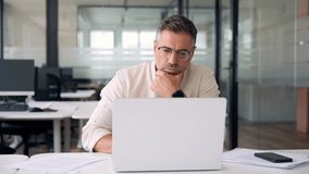 Mature Indian or Latin business man ceo trader using computer, typing, working in modern office, doing online data market analysis, thinking planning tech strategy looking at laptop with copy space. - Powered by Shutterstock - Get 15% off with code: PIKWIZARD15