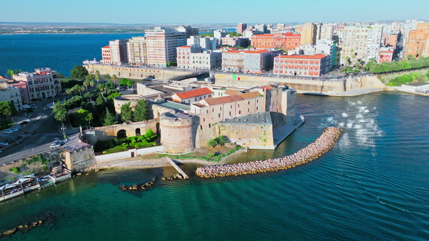 Scenic aerial view of a golden sunset over Castello Aragonese in Taranto, Italy. View from above over Bridges that link the mainland to the old town, stunning view of the European cruise port.