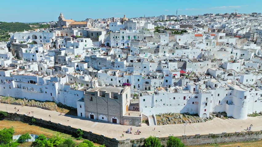 View from above over Ostuni city in Italy’s Apulia region. Aerial view of whitewashed old Italian town in Europe.