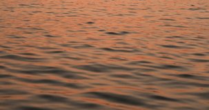4K Blurred video of romantic colored sea at sunset time, a mixture of red and dark colors