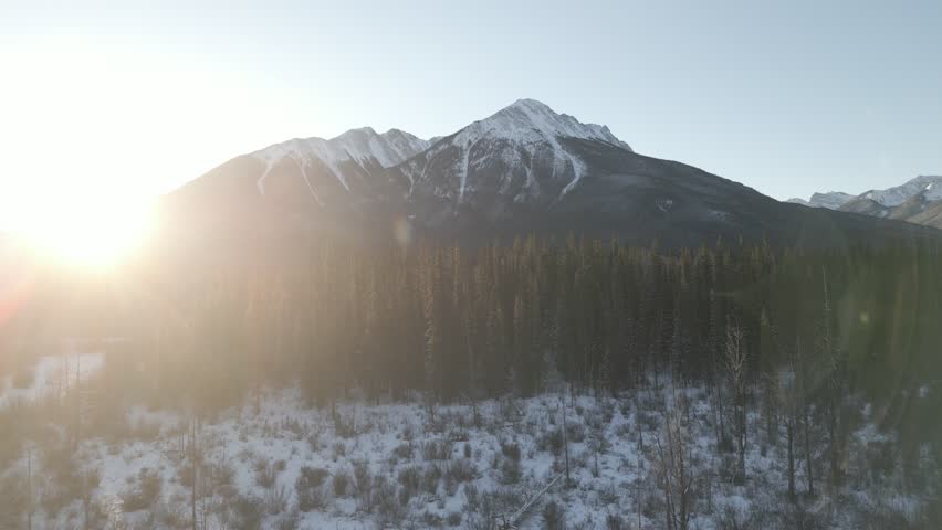 Aerial video flying sideways over Banff National Park in winter Canada