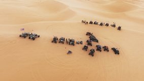 Sport recreation concept for men 4K. Aerial view of ATV buggy sport cars gathering on sand dunes. Four wheel drive vehicles competition on dunes. Scenic view of Extreme sport outdoor hobby on weekend - Powered by Shutterstock - Get 15% off with code: PIKWIZARD15