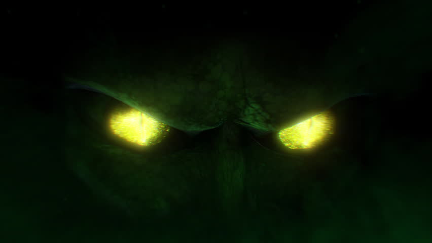 Out of the darkness we are close in on the head of a reptilian being as we see it’s eyes open and blink, surrounded by atmospheric smoke, light effects highlight the scaled skin.