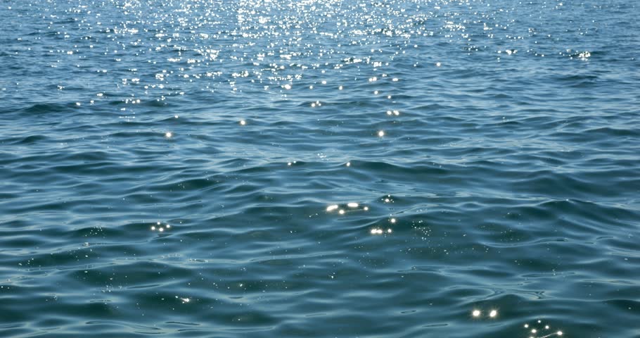 Sunbeams on the blue water of the Adriatic Sea.