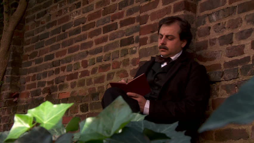 RICHMOND - SUMMER 2022 - Actor portrayal of American macabre poet and author Edgar Allen Poe - thinking and writing in an ancient memorial garden. deep in thought, composing into a book.  Manuscript. Royalty-Free Stock Footage #1104054611