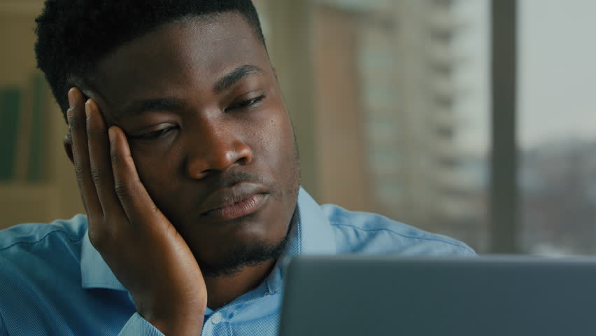 Tired multiracial businessman overworked computer laptop remote job drowsy exhausted lazy African American man unmotivated employee manager worker sleep low energy monotone boring work in home office Royalty-Free Stock Footage #1104057243
