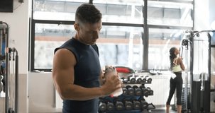 Man mixing a protein shake in a gymnasium