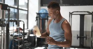 African man drinking a protein shake in a gym