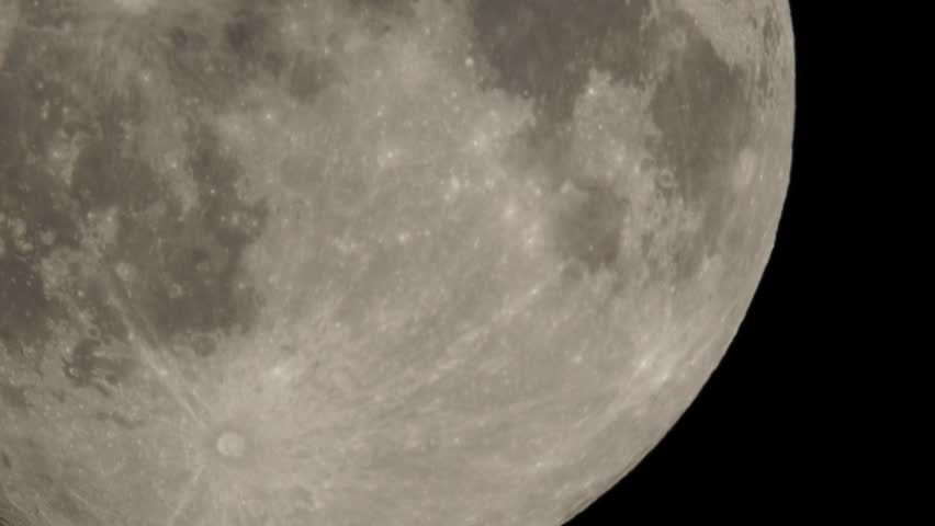 Full moon moves slow at night sky. Sharp footage of full moon with telephoto lens close-up. Moon shot from ground. Moon witchcraft magic ritual concept.