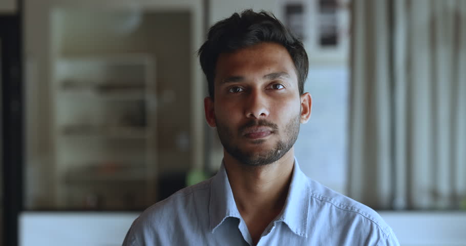 Head shot of successful millennial Indian business man posing at workplace, staring at cam feels satisfied with career growth in company, portrait of corporate male employee, professional occupation Royalty-Free Stock Footage #1104073279