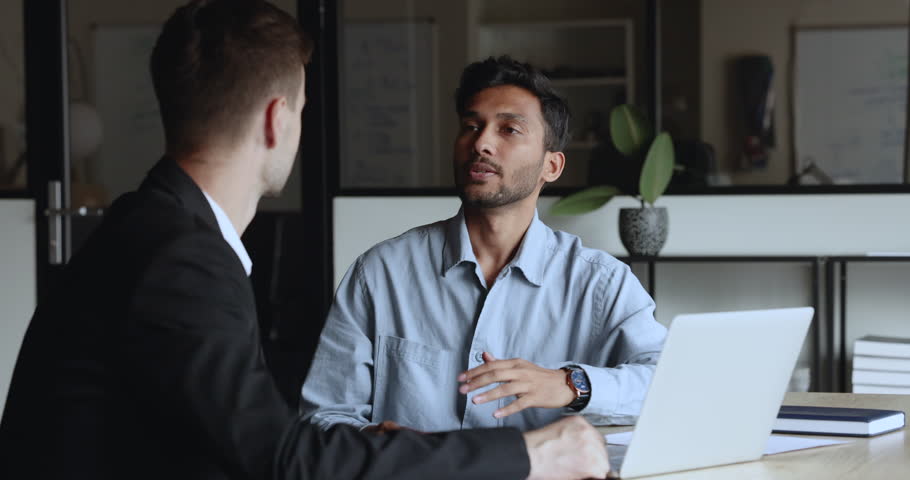 Male advisor, salesman talk with client sit at modern office with laptop, close deal at business meeting, make bank loan insurance investment deal agreement, thanking for cooperation, shaking hands Royalty-Free Stock Footage #1104073309
