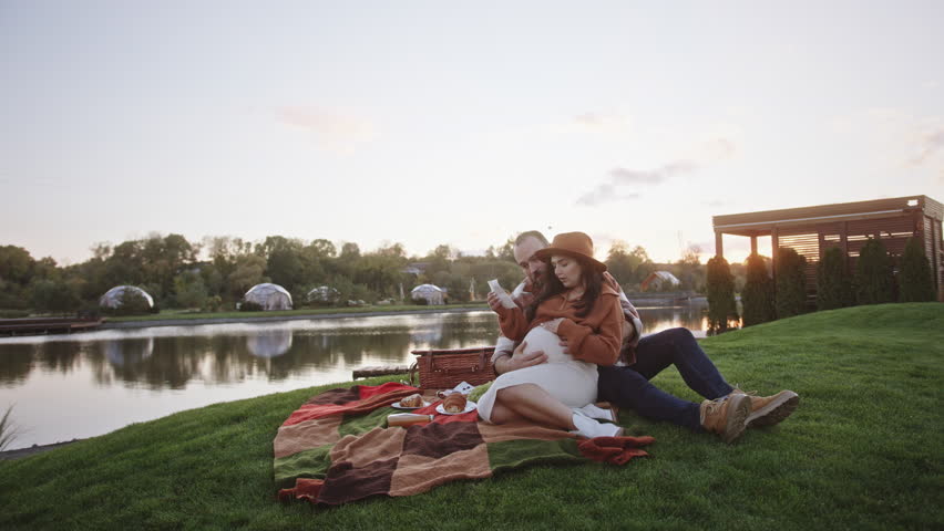 Husband and wife look together at baby ultrasound photo