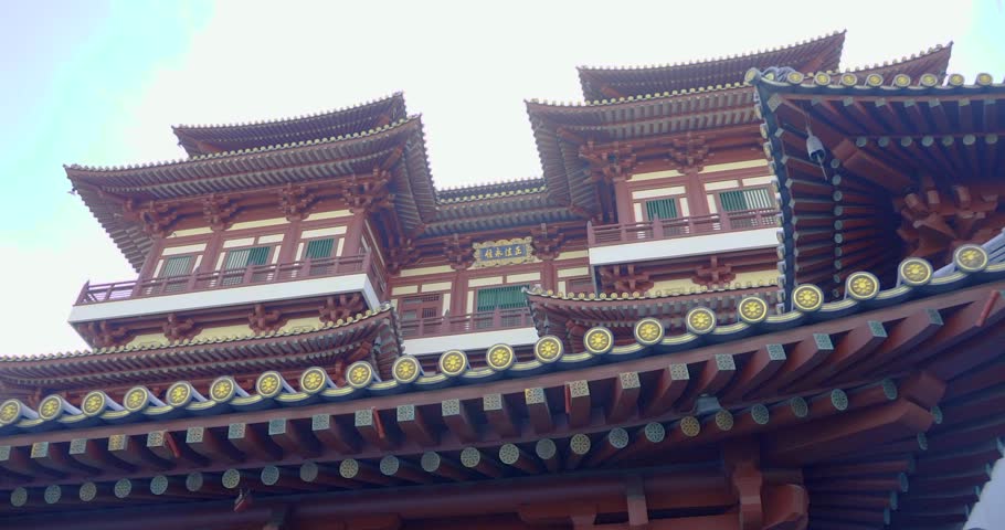 Buddha Tooth Relic Temple, china town, slow motion shot of the entrance with tree leaves as foreground, mid day noon shot, Singapore, Smooth 4k Footage