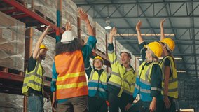 Team of factory workers celebrate a great success by putting hands together in the retail warehouse full of shelves. - Powered by Shutterstock - Get 15% off with code: PIKWIZARD15