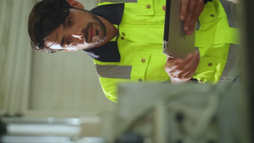Engineer checking and maintenance machine at factory. He looking to machine and checking how it work. professional, industry and machinery concept.