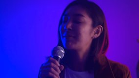 
Happy feeling Attractive singer woman singing music on stage with spotlight neon lights at concert event. Beautiful female musician performing live with neon light and smoke at hall in party. - Powered by Shutterstock - Get 15% off with code: PIKWIZARD15