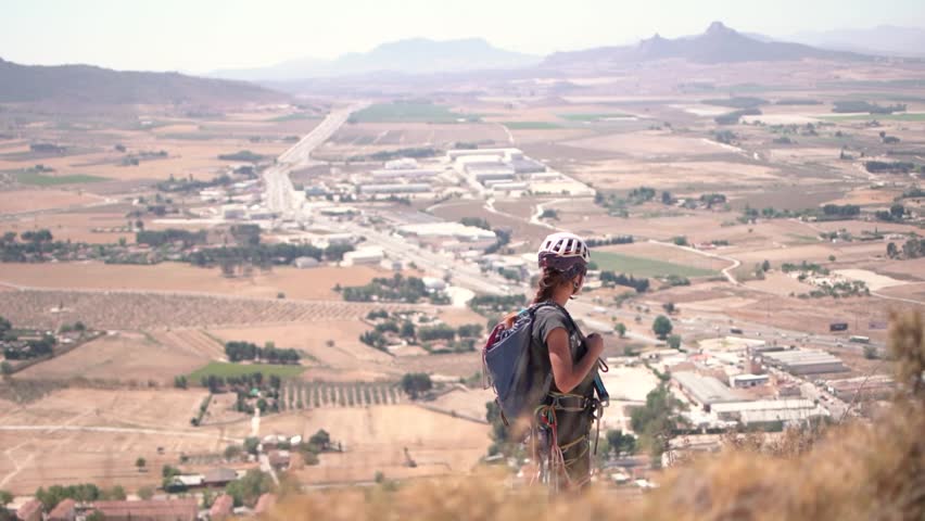 Via ferrata ascension by a couple sportsmen. View of mountain and mountaineers climbing in Alicante, Spain.