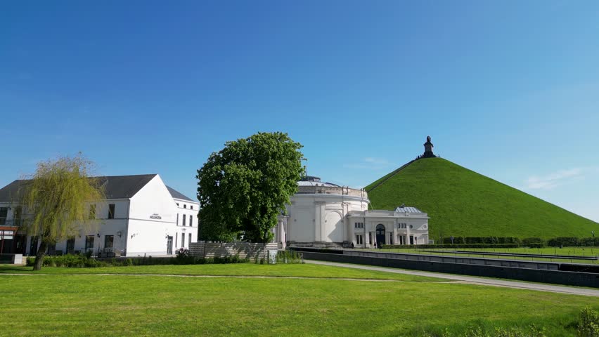 Aerial view fly over of the Lion's Mound in Waterloo panning over the canons and finishing with a panoramic scene, shot by a drone. High quality 4k footage