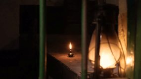 A hurricane lamp by the window and an oil lamp in the far room illuminate the room in the evening. Kerosene lamp close up view. - Powered by Shutterstock - Get 15% off with code: PIKWIZARD15