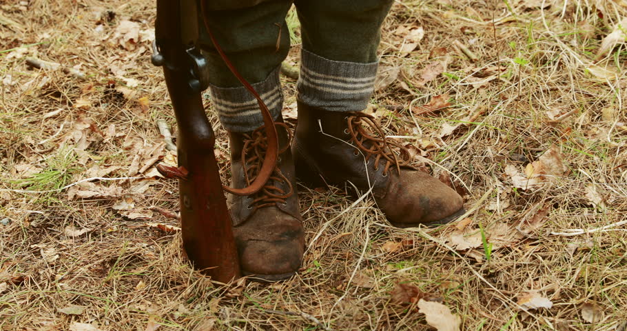 Close Up Of German Military Ammunition Of A German wehrmacht Soldier. World War II German Soldier Standing Order With Rifle.