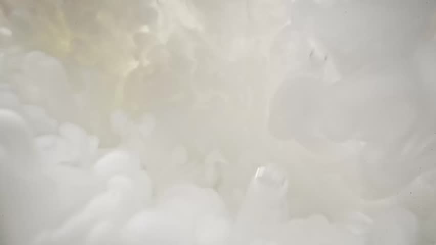 Milk is poured into water. View under water.