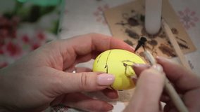 Preparation for the holiday, paint eggs with paints, draw a flower.