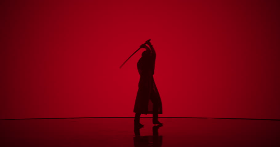 Athletic Man Practicing Kendo Martial Arts with a Katana or a Bamboo Sword. Male Does Cosplay, Swinging the Cold Weapon in a Modern Dojo Style Digital Space with a Red Backdrop on a Screen