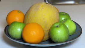 Macro Detail shot 4K video made of melon apple orange served presentation on wooden table in fruit plate buying now. 