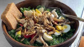 Seasonal salad with mushroom and egg served in wooden bamboo bowl on wooden background Macro Detail shot different alternative angles 4K video footage healthy lifestyle healthy food buying now.
