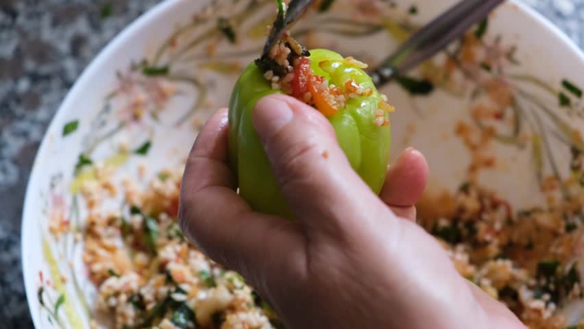 Stuffed Peppers Turkish Traditional famous dish. Woman preparing stuffed peppers. Biber Dolmas Royalty-Free Stock Footage #1104101357