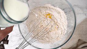 pour the milk into a glass bowl for kneading the dough - Powered by Shutterstock - Get 15% off with code: PIKWIZARD15