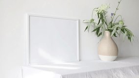 Video white photo frame mockup with beige vase with eucalyptus 
