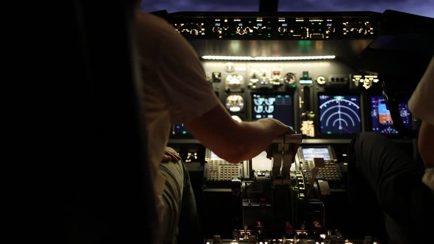 Back view of the pilots in the cockpit. They use control panel and navigation instruments. Training process. Flight control concept. Aircraft flight simulation. Royalty-Free Stock Footage #1104105581