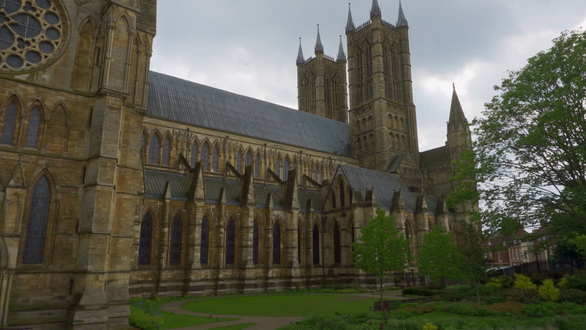 Cinematic footage of the majestic and historic Lincoln Cathedral. Showing stone walls, stained glass windows and stone towers - Powered by Shutterstock - Get 15% off with code: PIKWIZARD15