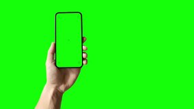 A set with a phone in hand with a green screen and tracking markers, along with a hand tapping a display. The video includes a luma matte mask, and you can set the screen tap wherever you want