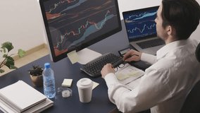 Businessman trading stocks online. Stock investor discussing numbers at graphs while video conversation with his colleague. Business team planning and analysing stock market graphs