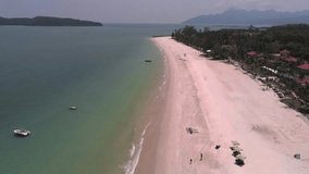 Sea shore with boats, sandy beach with sun umbrellas on sunny day. Aerial view, drone shot. Travel, vacation concept