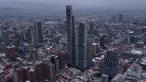 Video recorded in 4k with a drone over the center of Bogota on a cloudy and gray day.