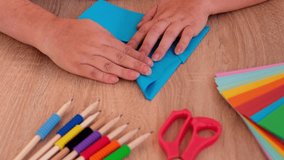 closeup woman holding colored paper, material for scrapbooking, origami, folds figures from paper, envelope in Japanese origami technique, concept of creating by hand for children's game - Powered by Shutterstock - Get 15% off with code: PIKWIZARD15
