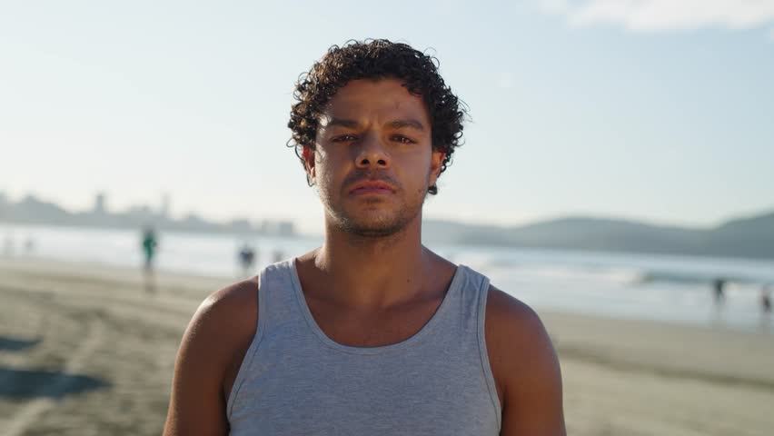 Portrait of serious latino young man stands posing outdoors at the beach looking at camera. Close-up sad mixed race male 
 Royalty-Free Stock Footage #1104122817