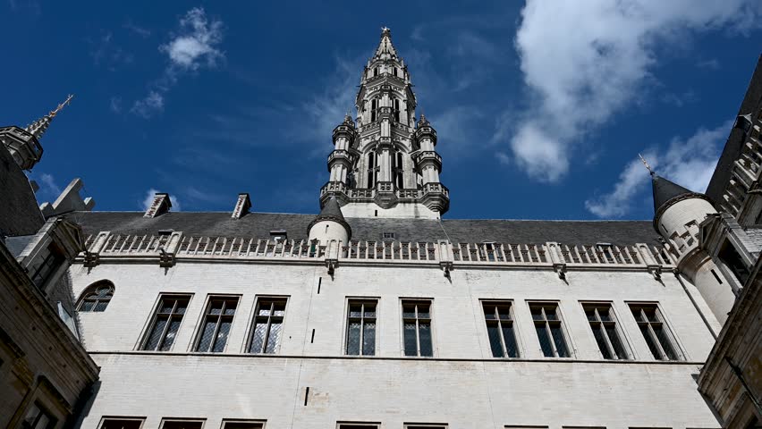 Brussels, Belgium: Time lapse of Town hall in city centre. Clouds passing by. Historic building in city of Bruxelles. 