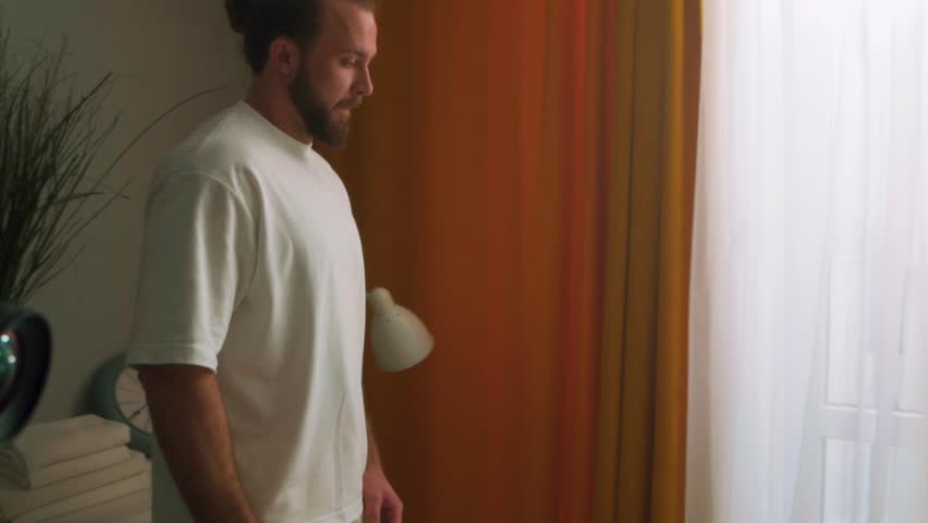 bearded handsome guy walking in bedroom to wake up his wife, for early healthy meal in romance for special day love, care, slow motion Husband touching his girlfriend's palm hand, she is stretching Royalty-Free Stock Footage #1104125509